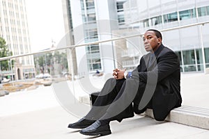 African Business Man Sitting at Office Building