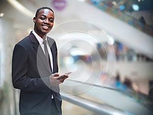 African business man in suit using smartphone with smile and happy