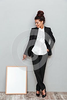 African business woman near copyspace board.