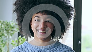 African business woman taking off an hygienic mask while smiling while looking at camera at the office.