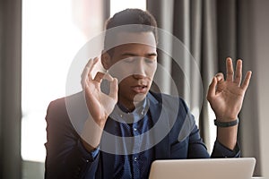 African businessman closed eyes folded fingers reduce stressful situations