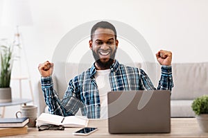 African Businessman At Laptop Gesturing Yes Celebrating Success In Office