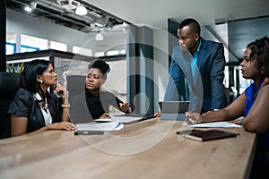 African businessman meeting with his staff during a meeting