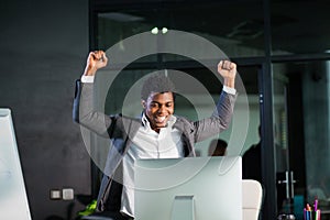 African businessman at office, success gesture, goal reached, happy man