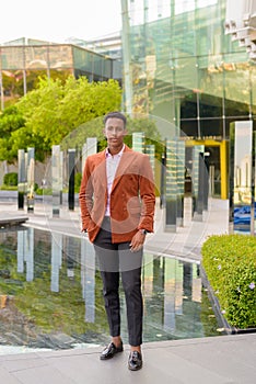 African businessman outdoors in city full length shot
