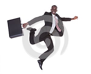 African businessman running holding briefcase