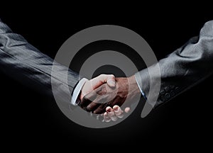 African businessman`s hand shaking white businessman`s hand.