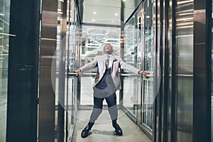 African Businessman screaming in elevator. fear claustrophobia concept