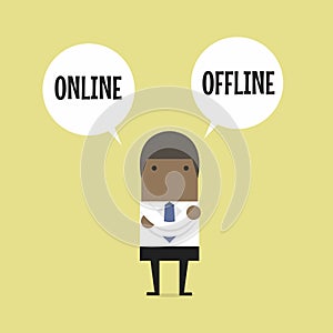 African businessman standing confuse to choose between two option online or offline.