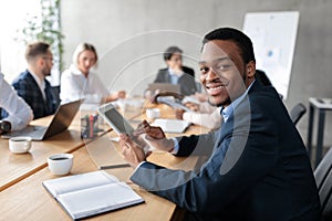 African Businessman Using Digital Tablet At Corporate Meeting In Office