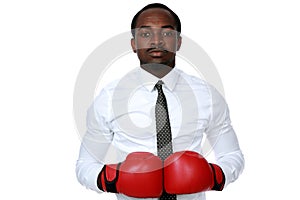 African businessman wearing boxing gloves