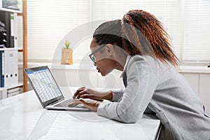 African Businesswoman Analyzing Gantt Chart On Laptop