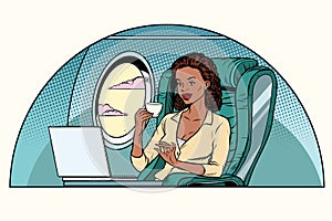 African Businesswoman in business class of the aircraft works at