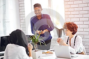 African businesswoman giving presentation to executive caucasian team in meeting room