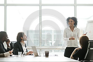 African businesswoman giving presentation working with flipchart