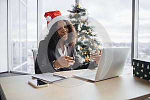 African businesswoman talking to client over video call.