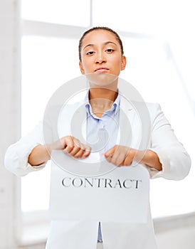 African businesswoman tearing contract