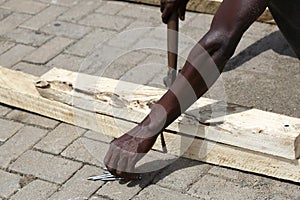 African carpenter works with wood