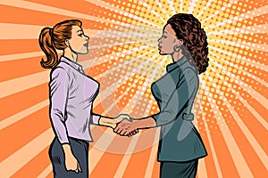 African and Caucasian businesswomen shaking hands