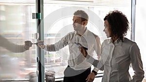 African and caucasian entrepreneurs writing on white board presentation