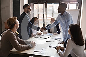 African caucasian ethnicity businessmen party leaders shaking hands starting negotiations