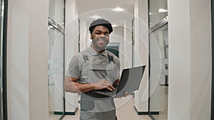 African CCTV cameras installer in office corridor