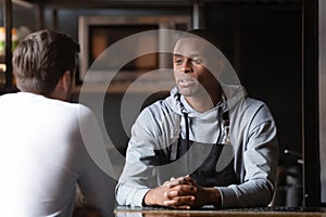 African chef talking with caucasian male vacancy candidate in restaurant