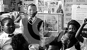 African children in a classroom, raising hands and talking in the Primary school in South Africa