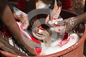 African Children Washing Laundry at Home as a Water Scarcity Con