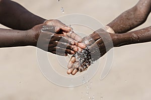 African Children Washing their Hands with Water Outdoors