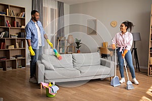 African Couple Cleaning Room Doing House Chores Together At Home