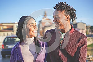 African couple having fun outdoor in city tour - Young people lovers enjoying time together during vacation journey - Love,