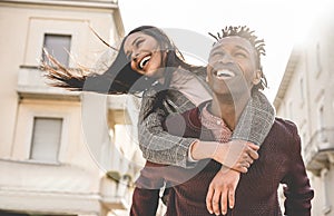 African couple having fun outdoor in city tour - Young people lovers enjoying time together during vacation journey - Love,