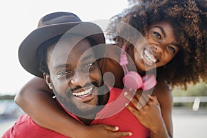 African couple having fun together outdoors - Focus on man face