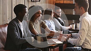 African couple making agreement handshaking caucasian lawyer in coffee house