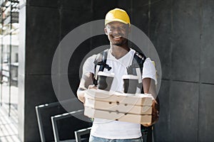 African courier delivering boxes with pizza and hot coffee.