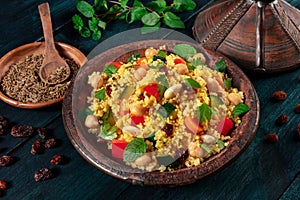 African couscous in the tagine, with spices and herbs