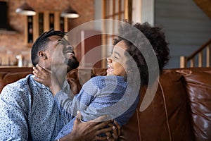 African dad having fun with little 6s daughter at home