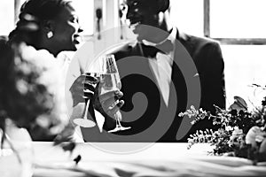 African Descent Bride and Groom Clinking Glasses Together