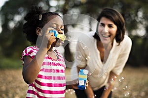 African descent girl is playing bubbles photo