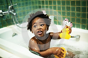 African descent kid enjoying bath tub photo