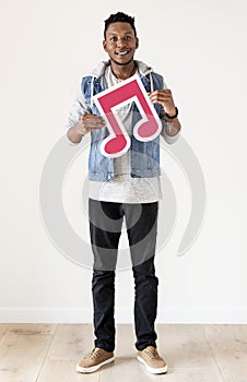 African descent man holding a musical note icon