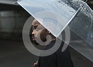 African descent man in an umbrella