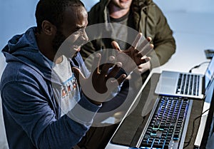African descent man is working with computer laptop