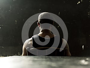 African descent sitting on a chair in the dark