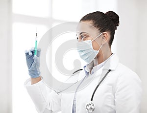 African doctor holding syringe with injection