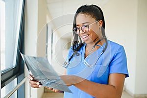 African doctor looking at patient`s x-ray at hospital