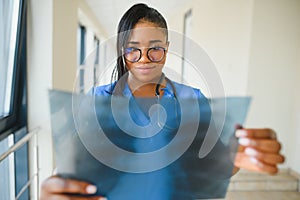 African doctor looking at patient`s x-ray at hospital