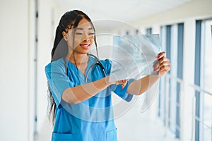 African doctor looking at patient`s x-ray at hospital