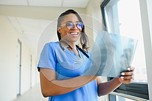 African doctor looking at patient`s x-ray at hospital